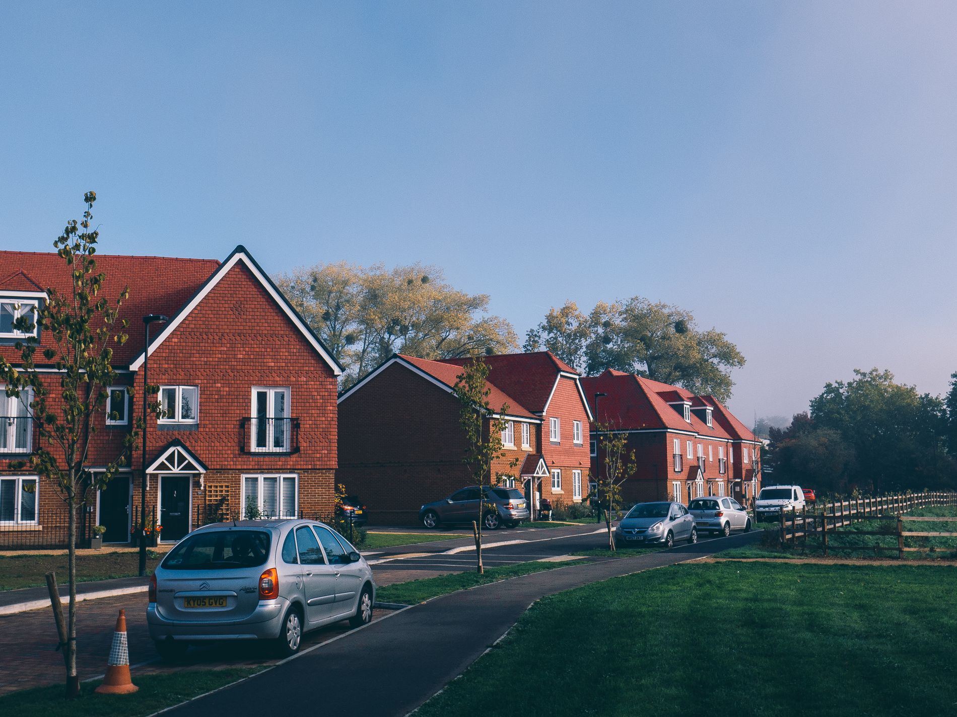 Picturesque view of a serene suburban neighborhood with parked cars in Farnham, England.